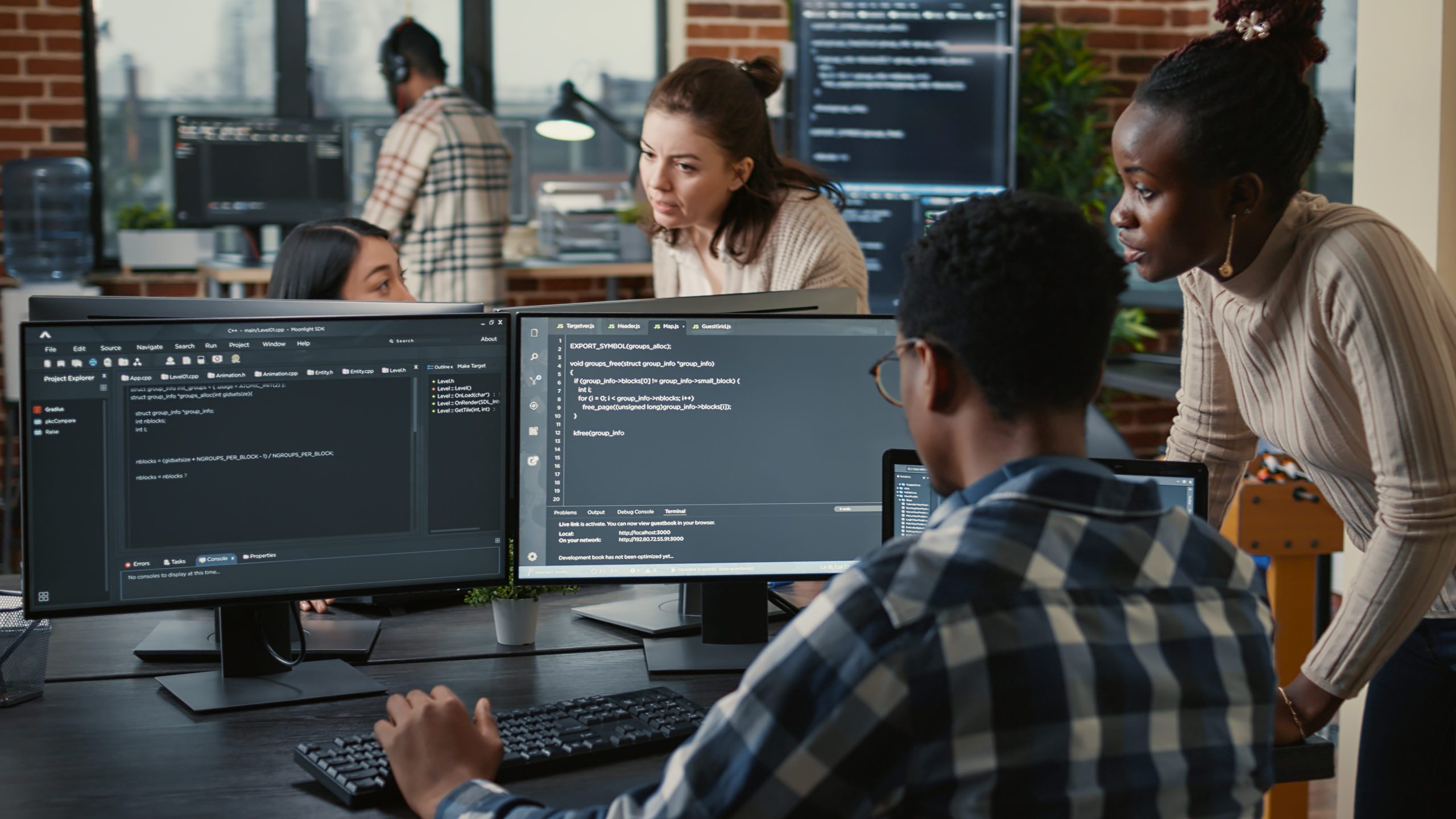 Mixed team of artificial intelligence cloud programers talking about programming in front of multiple screens Skyrocket