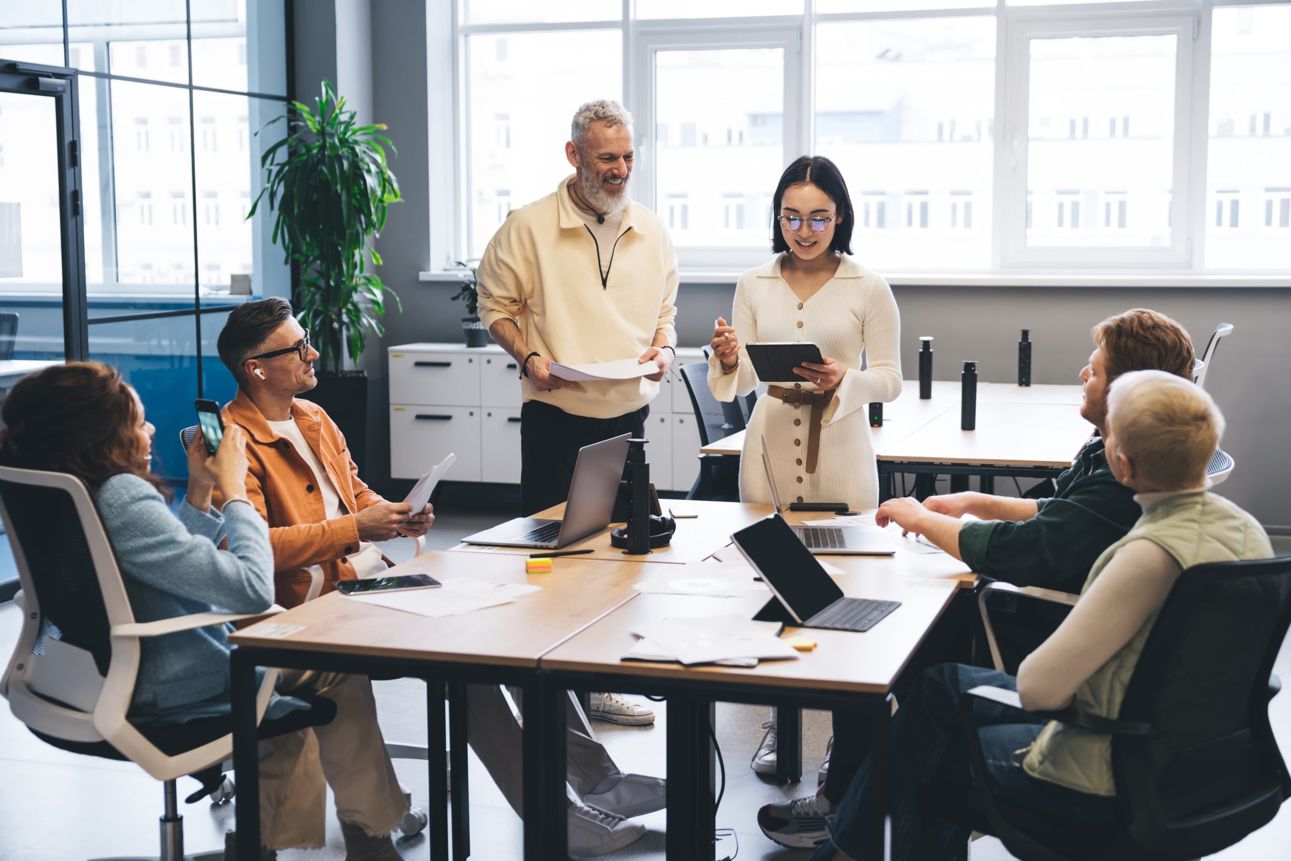 Group of multiethnic coworkers sharing ideas on business project Skyrocket